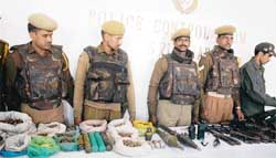Security forces display arms and ammunition recovered from top Hizbul Mujahideen militant Rais Ahmad Dar at the police headquarter in Srinagar