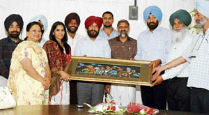 Gursimran Kaur being honoured by members of the Punjab basketball association at Guru Nanak stadium in Ludhiana on Monday. 