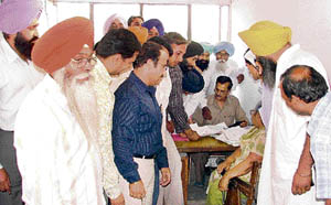 Representatives of various departments of Punjab Agricultural University gather at the audit branch to get their files cleared in Ludhiana on Monday. 