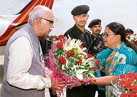 BJP leader L.K. Advani is greeted by Rajasthan Chief Minister Vasundhara Raje Scindia on his arrival in Jaipur
