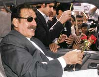 Pakistan's deposed chief justice Iftikhar Chaudhry holds flowers given by his supporters outside his residence in Islamabad on Monday. Chaudhry left for Quetta to address his first lawyers' meeting after being released from five months' house arrest