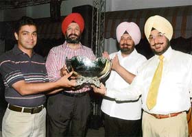 Captain of the course Sukhjeet Singh Lehal (extreme left) and Golf Club president R.S. Sandhu give away the Independence Day Cup to G.S. Kochhar and Arvind Bajaj
