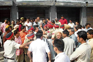 The police tries to control residents of Gandhi Colony and workers of a liquor vend in Ludhiana on Tuesday. 