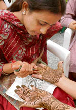 Members of the Evergreen Women Association participate in a mehndi competition organised by Kiddies Paradise School in Ludhiana. 