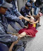 Riot police try to detain a Tibetan monk for protesting outside the Chinese embassy in Kathmandu on Tuesday. Dozens of Tibetan monks and activists were detained after shouting anti-China slogans and yelling Free Tibet in Kathmandu on Tuesday