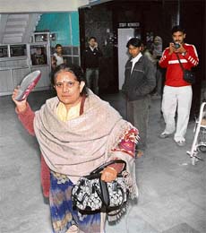 Giani Devi tries to shoo away photographers inside Shimla's IGMC hospital where her husband former Congress minister Singhi Ram was admitted after he complained of chest pain and high blood pressure