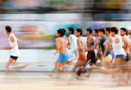 Youths run as part of a physical fitness test during a recruitment drive organised by the Jammu and Kashmir police in Jammu on Tuesday.