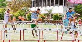 Athletes participate in hurdles race