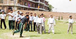A student participates in the shot put event at Gopalpur in Mandi Ahmedgarh