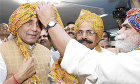Farmers honour BJP President Rajnath Singh during the launch of a Kisan Adalat Movement at the party's office in New Delhi on Wednesday.