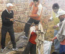 Deputy commissioner B.S. Malik takes part in a cleanliness drive in a village near Karnal.