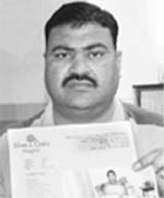 V.P. Goel with the hospital report and his daughters picture in Mohali