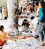 Customers pick out items from a squatter in Sector-17 plaza, Chandigarh