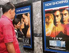 A couple take a look at the poster of Pakistani film Khuda Ke Liye (In The Name of God) at a cinema hall in New Delhi on Friday.