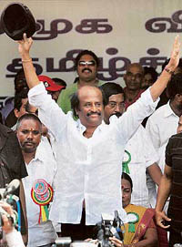 Actor Rajnikanth waves at the crowd during the one-day fast, organised to condemn the attack on cinema halls screening Tamil movies in Bangalore in the wake of the Hogenakkal issue, in Chennai on Friday.