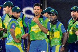 Abdul Razzak celebrates the fall of Heroes last wicket with team-mates at Panchkula on Friday night.