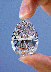 A model holds a 72.22-carat diamond with an estimated price of $10-13 million during its preview at Sotheby's auction house in Hong Kong on Saturday. The diamond will go to auction in New York on April 17. 