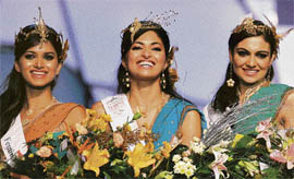 Newly crowned beauty pageant entrants (from L to R) Miss India Earth Harshita Saxena, Miss India World Parvathy Omanakuttam and Miss India Universe Simran Kaur Mundi smile as they pose for a photo during the Miss India @@pageant contest in Mumbai on Saturday.