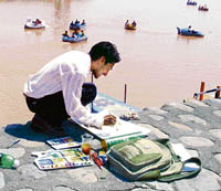 A participant during the painting contest at Sukhna Lake in Chandigarh on Sunday.