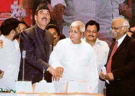 Union railway minister Lalu Prasad Yadav along with Jammu and Kashmir Chief Minister Ghulam Nabi Azad flags off Garib Rath by pressing a button at the function at General Zorawar Singh Auditorium in Jammu University on Sunday. 