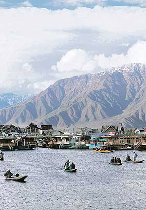 Kashmiris row boats on the waters of the Dal Lake in Srinagar.