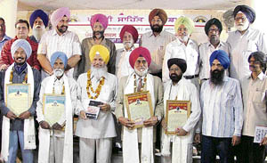 Minister Hira Singh Gabria with Punjabi Ghazal Manch award winners in Ludhiana on Sunday. 