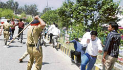 Policemen lathicharge contractual computer teachers after they blocked the car of local bodies minister Manoranjan Kalia outside Desh Bhagat Yadgaar Hall at Jalandhar on Sunday. 