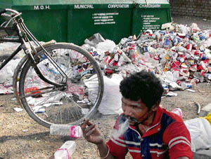 Even as seminars and talks were organised in Chadigarh on the World Health Day, a smoker oblivious to the harmful effects of smoking and the ban on it, puffs all health concerns away near a heap of garbage, in Chandigarh on Monday. 