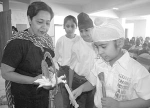 A student lights a lamp while principal Komal Singh looks on during the orientation programme in The Millennium School, Sector 67, Mohali, on Monday. 