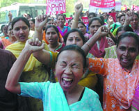 Public health employees hold a demonstration against the 6th Pay Commission under the banner of the National Public Health Alliance at Jantar Mantar in the Capital on Monday.