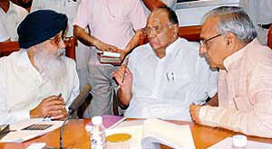 Union food and agriculture minister Sharad Pawar discusses a point with Punjab and Haryana chief ministers Parkash Singh Badal (R) and Bhupinder Singh Hooda, in Chandigarh on Monday.