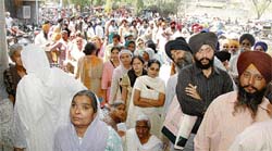 Victims of 1984 riots wait for their turn outside the Bachat Bhawan in Ludhiana