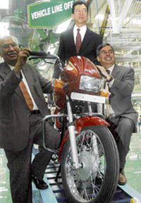 From left: Hero Honda chairman Brijmohan Lal Munjal, Fumihko Ike, COO, Asia, and Pawan Munjal, managing director, at the inauguration of their plant in Hardwar on Tuesday. 