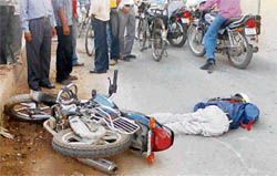 A motorist, who met with an accident, lies on Chandigarh-Ambala road at Zirakpur on Wednesday.