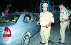 Noida Police personnel inspect the spot where Shiva J Thomas was shot dead in Noida 