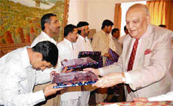 Jammu and Kashmir Governor Lt-Gen S.K. Sinha (retd) giving gifts to Pak Hindu pilgrims who had come to visit Mata Vaishno Devi shrine in Katra, Jammu, on Wednesday.