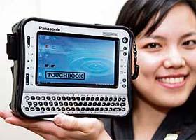An employee for Japanese electronics giant Matsushita Electronics displays the prototype model of the heavy-duty handheld PC Toughbook in Tokyo