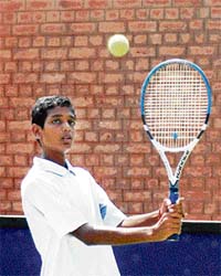 R. Ramkumar of Tamilnadu hits a backhand shot during a semifinal match of under-14 at CLTA