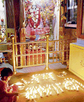 A child lights earthen lamps at Mata Sankat Mochan Mandir in Rohtak on the occasion of Navratras.