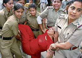 Police personnel take an injured anganwadi worker to hospital in Chandigarh on Thursday. 
