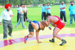Indian and Pakistani wrestlers grapple during the 27th sub-junior national wrestling championship in Jalandhar