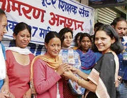 Hamirpur DC Nandita Gupta offers juice to fasting computer teachers after they called off their agitation on Friday.