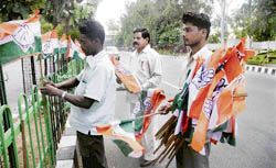 Congress workers putting up flags on a Jammu road on the eve of Sonia Gandhis visit to Jammu
