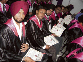 Students show their degrees during the annual convocation of Bhutta College of Education and Bhutta College of Engineering near Ahmedgarh on Friday.