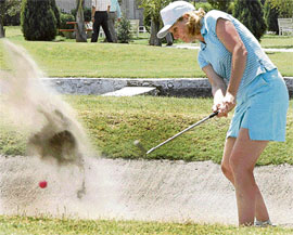 Cathie King of the Canadian High Commission is caught in a bunker in the Chandigarh Golfing Tour at the Panchkula Golf Club on Saturday.