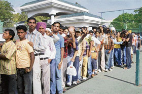 People line up during the sale of tickets for the forthcoming IPL match at PCA, Mohali, on Saturday.