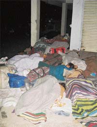 Pilgrims sleep by the roadside for want of accommodation in Kangra town