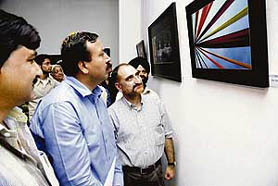 Divisional Commissioner, Jammu, Sudhanshu Pandey watching a photo exhibition Utsav during the Jammu Festival on Saturday.