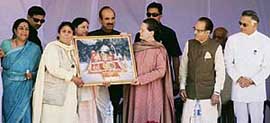 Congress workers presenting a picture of Mata Vaishno Devi to AICC president and UPA Chairperson Sonia Gandhi during a public rally in Jammu on Saturday.
