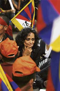 Writer Arundhati Roy chats with Tibetan monks during a protest in New Delhi